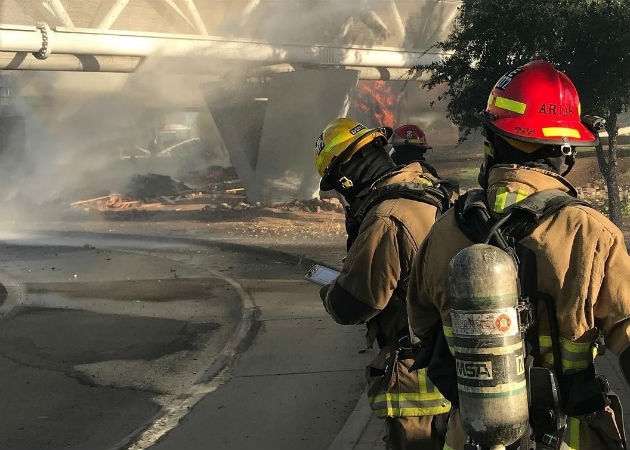 Tren se descarrila sobre un puente en EE.UU. y causa un aparatoso incendio Bomberos trabajan en apagar el aparatoso incendio tras el descarrilamiento de un tren. Fotos: EFE.