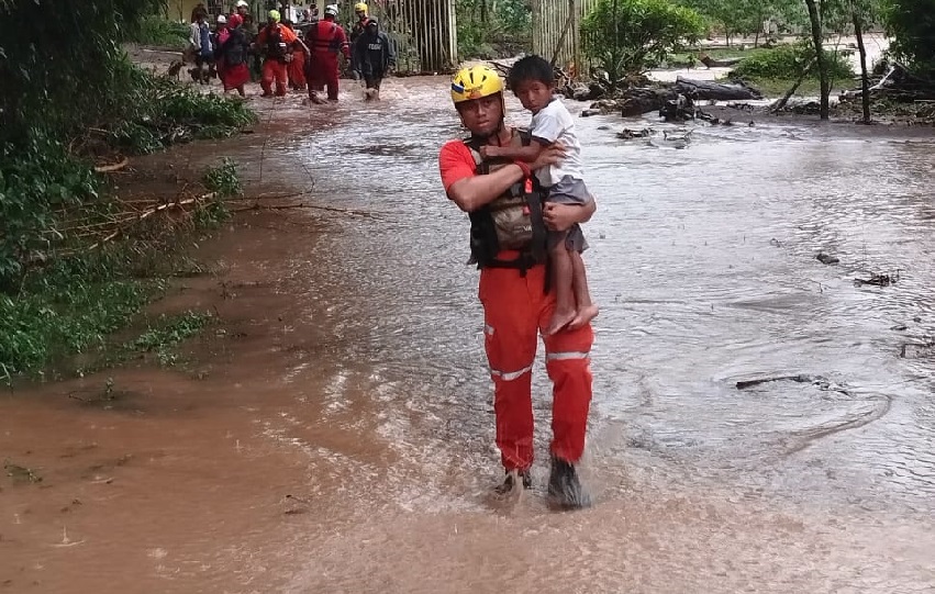 Personal de Sinaproc ayuda a un grupo de personas a salir de un área inundable. Foto. Sinaproc Personal de Sinaproc ayuda a un grupo de personas a salir de un área inundable. Foto. Sinaproc