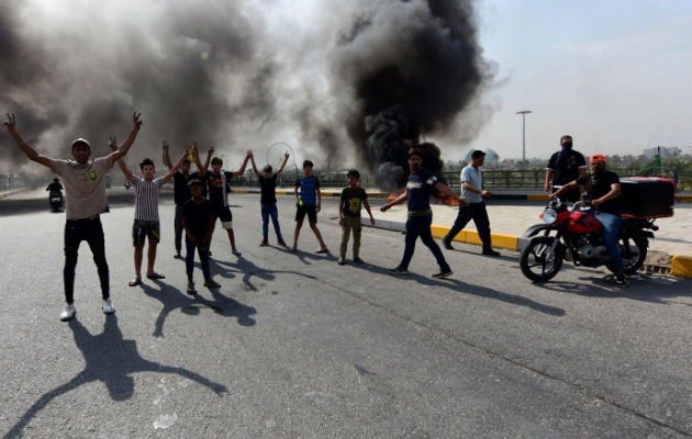 Al menos dos nuevos muertos al intensificarse las protestas en Irak Manifestantes iraquíes queman llantas durante las protestas en Bagdad. Foto: EFE.