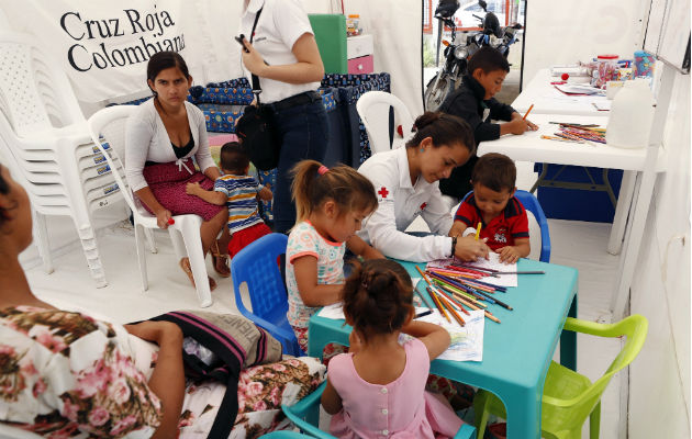 Cientos de venezolanos llegan en lancha a refugio médico en Colombia Personal de la Cruz Roja Colombiana atendiendo población venezolana en Arauca. Foto: EFE.