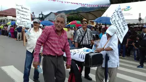 Jubilados desfilan con ataúd ante Varela para exigir pago de décimos