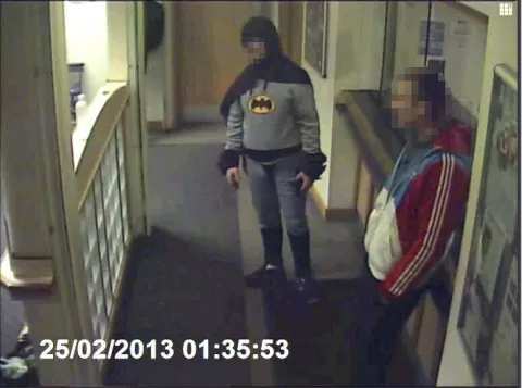 Hombre vestido de Batman entrega a un delincuente en una comisaría