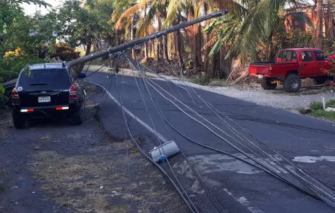 Camión colisiona con poste eléctrico causando daños a los autos estacionados