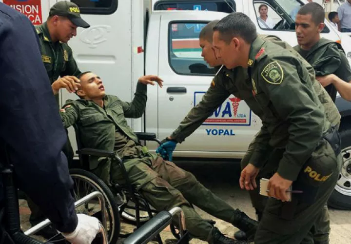 Integrantes de la policía de Colombia trasladando a un agente herido. Foto:EFE