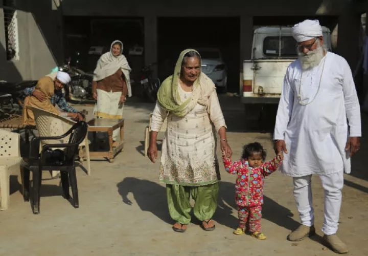 Manjeet Kaur, y su esposo Gurdev Singh, caminan con su hija Gurjeet Kaur. FOTO/AP