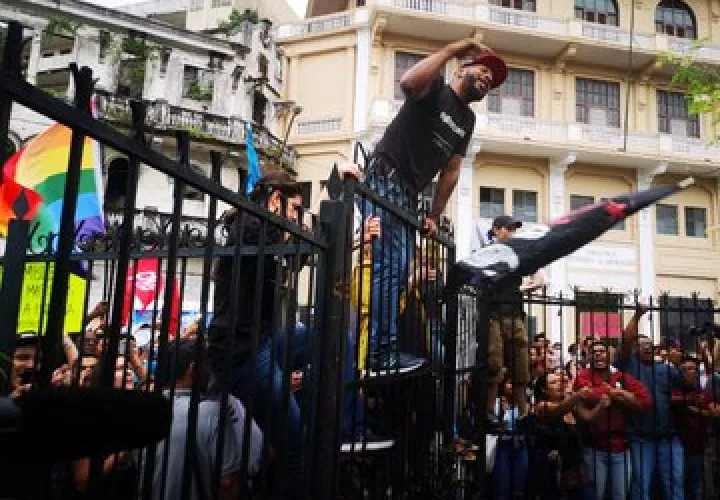 Los manifestantes se subieron a la cerca de la Asamblea Nacional para protestar en contra de las reformas constitucionales.