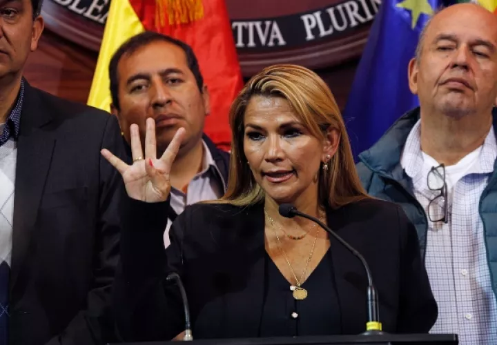 Jeanine Anez, la segunda vicepresidenta del Senado, muestra un signo de paz mientras da una conferencia de prensa en el Congreso en La Paz, Bolivia. FOTO/AP