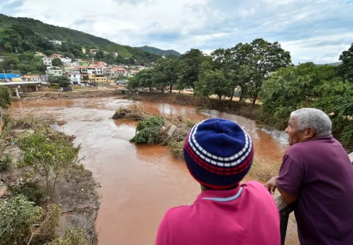 Vecinos miran los daños causados por el desbordamiento del río Das Velhas, tras las lluvias torrenciales, en Sabara, en la región metropolitana de Belo Horizonte, estado de Minas Gerais (Brasil). El número de muertos por las fuertes lluvias que castigan desde el jueves el estado brasileño de Minas Gerais (sudeste) llegó a 54. FOTO/EFE