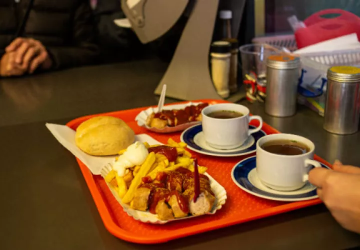 Konnopke’s se adaptó a los gustos de los alemanes occidentales en 1990. Currywurst rebanada y papas a la francesa. Foto / Lena Mucha para The New York Times.