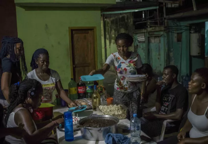Migrantes de Camerún festejan un cumpleaños en un bar en Tapachula, México. Foto / Daniele Volpe para The New York Times.
