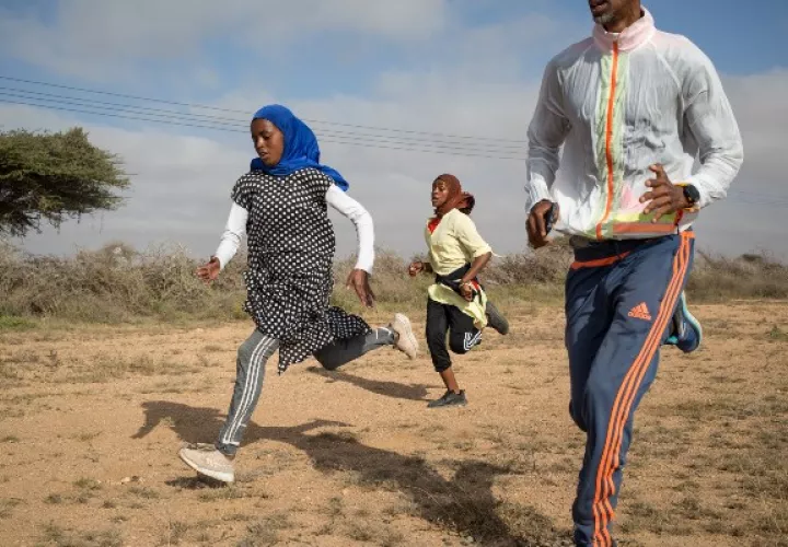 Hamda Abdi Dahir (izq.) y Hanna Mukhtar entrenan con su coach. Más mujeres acogen el deporte. Foto / Mustafa Saeed para The New York Times.