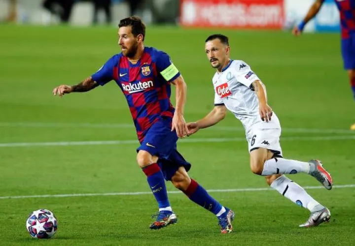 Messi conduce el  balón ante el acecho de un jugador del Nápoles. Foto:EFE