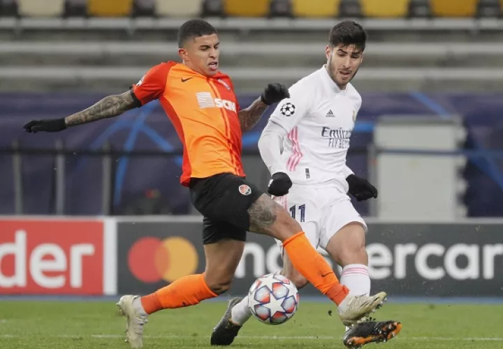 Dentinho del Shakhtar (izq.) disputa el balón contra  Marco Asensio del Real Madrid. Foto:EFE