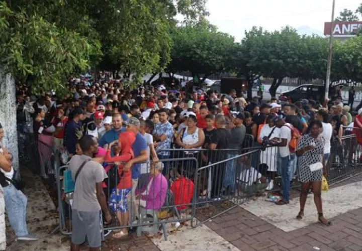 Migrantes hacen fila mientras esperan para regularizar su documentación en el municipio de Tapachula. Foto: EFE
