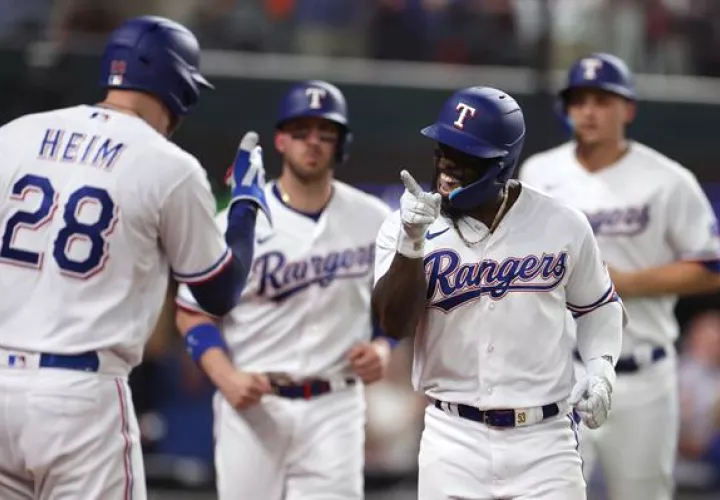 El cubano Adolis García (der.) de los Rangers festeja su cuadrangular. Foto: EFE