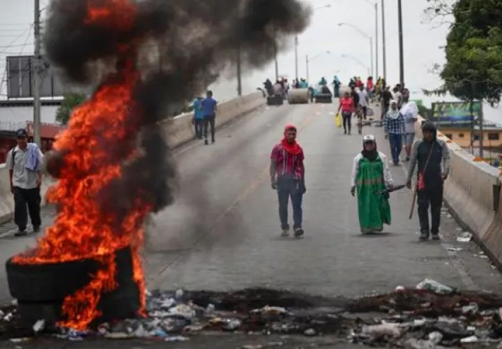  Manifestantes cierran la vía Panamericana durante una protesta en contra del contrato minero. Foto: EFE
