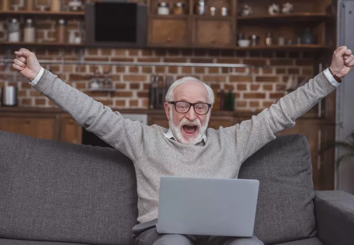 happy-grey-hair-man-watching-on-laptop-at-home-and-2023__0.jpg