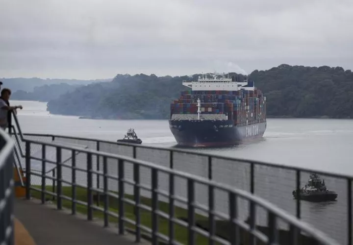 Personas observan el tránsito de un buque este viernes por las esclusas de Agua Clara, en el Canal de Panamá (Panamá).  EFE