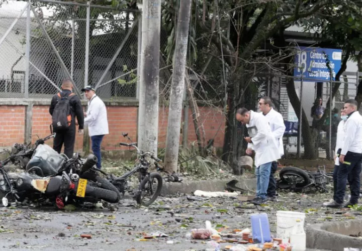 Peritos forenses trabajan en los alrededores de la estación de policía del barrio Meléndez donde ocurrió un atentado. Foto: EFE