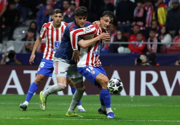 El defensa colombiano del Arsenal Piero Hincapie (izq.), pelea por el balón ante el defensa del Atlético de Madrid, Marc Pubill. Foto: EFE