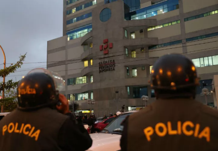 Integrantes de la policía en Perú vigilan afuera de la clínica. Foto: EFE