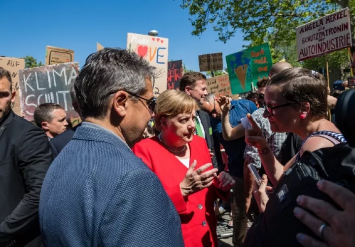 La canciller alemana, Angela Merkel (c), charla con activistas medioambientales durante la visita que realizó a la ciudad de Goslar, Alemania. FOTO/EFE