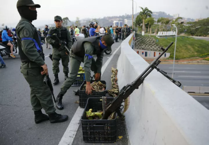 Los soldados toman posiciones en un paso elevado próximo a la base aérea de Carlota en Caracas, Venezuela. FOTO/AP